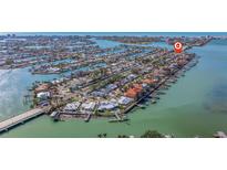 Aerial view of waterfront homes with docks on a sunny day near a bridge at 7998 Causeway N Blvd, St Petersburg, FL 33707
