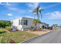Charming single-story home with well-maintained landscaping, a driveway, and lush green grass at 845 Jolanda Cir, Venice, FL 34285