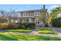 Charming two-story home featuring stone facade, mature landscaping, and a welcoming entrance at 864 15Th Ne Ave, St Petersburg, FL 33704