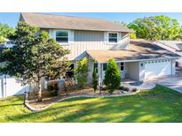 Charming two-story home boasts lush landscaping and a well-manicured lawn, creating a welcoming curb appeal at 1375 Corner Oaks Dr, Brandon, FL 33510