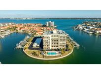 Stunning aerial view of the condominium with boat slips, pool, and beautiful landscaping at 1651 Sand Key Estates Ct # 53, Clearwater, FL 33767