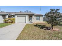 Charming home with a well-maintained lawn and attached one-car garage and neutral color scheme at 37850 Prairie Rose Loop, Zephyrhills, FL 33542