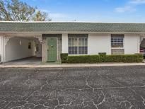 Charming single-story home featuring a green door and well-maintained front yard landscaping at 7816 38Th N Ter # 7816, St Petersburg, FL 33709