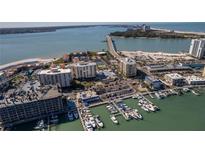 Gorgeous aerial view of waterfront condos, boat docks, beach, and scenic bridge in Clearwater Point at 830 S Gulfview Blvd # 501, Clearwater Beach, FL 33767