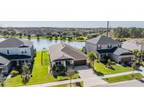 Charming home features a well-manicured lawn, mature trees, and water views at 33899 Astoria Cir, Wesley Chapel, FL 33545