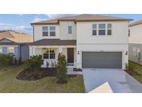 Charming two-story home with a well-maintained lawn, a two-car garage, and inviting curb appeal at 4255 Big Sky Dr, Spring Hill, FL 34604