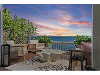 Seating area on patio with stunning sunset views over the Gulf of Mexico at 4966 Coquina Key Se Dr # 4966, St Petersburg, FL 33705