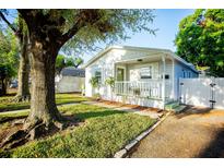 Charming single-story home with a cozy front porch and beautifully landscaped yard at 6906 N Central Ave, Tampa, FL 33604