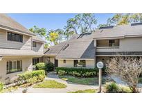 Attractive condominium with a well-manicured lawn and mature trees at 102 Old Mill Pond Rd, Palm Harbor, FL 34683