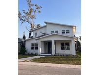 Stunning modern two-story home featuring a stylish architectural design, lush lawn, and well-manicured landscaping at 1030 11Th S Ave, St Petersburg, FL 33705