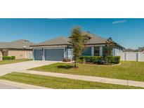 Charming single-story home featuring a two-car garage, well-manicured lawn, and beautiful landscaping in a tranquil neighborhood at 12749 Weatherstone Dr, Spring Hill, FL 34609