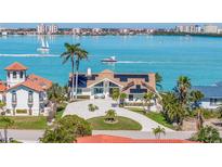 Stunning waterfront home boasts a private driveway, lush landscaping, and breathtaking ocean views at 173 1St W St, Tierra Verde, FL 33715