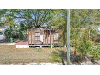 Stripped home features wood frame, no roof, with a small yard at 3601 N 18Th St, Tampa, FL 33605