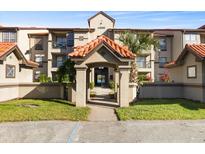 Beautiful condo building featuring manicured landscaping and attractive architectural details at 4209 Woodstorks Walk Way # 1304, Lutz, FL 33558