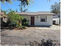 Charming single-story home featuring a red front door, white exterior, and small front yard at 4501 67Th N St, St Petersburg, FL 33709