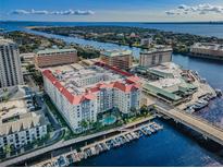 Beautiful aerial view of condominium complex with a pool and boat docks along the water at 700 S Harbour Island Blvd # 204, Tampa, FL 33602