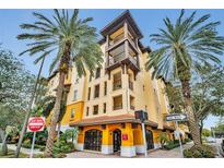 Beautifully designed condo building featuring balconies and a welcoming entrance, surrounded by palm trees at 100 4Th S Ave # 208, St Petersburg, FL 33701