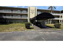 Exterior of a condo building, featuring well maintained landscaping and covered mailboxes and entry point at 1000 49Th N St # 309, St Petersburg, FL 33710