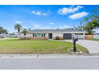 Charming single-story home with a well-manicured lawn and a classic brick accent wall at 269 Algiers Dr, Venice, FL 34293
