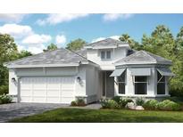 Charming single-Gathering home featuring a welcoming two-car garage and manicured landscaping at 29845 Imperati Blvd, Wesley Chapel, FL 33543