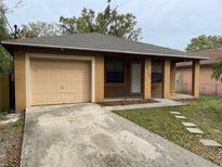 Inviting single-story home with attached garage and well-maintained front yard in a suburban neighborhood at 3112 E 8Th Ave, Tampa, FL 33605