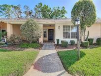 Charming single-story home featuring a well-maintained front yard with lush green grass and inviting walkway at 4955 Grist Mill Cir, New Port Richey, FL 34655