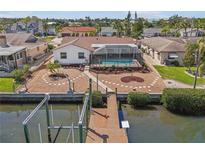Stunning waterfront home features a private dock, screened pool, and beautifully landscaped backyard at 709 Flamingo Dr, Apollo Beach, FL 33572