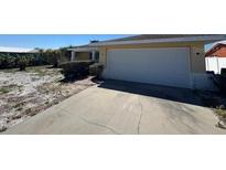 Single-story home featuring an attached two-car garage and a simple, low-maintenance landscape at 1016 Silver Palm Way, Apollo Beach, FL 33572