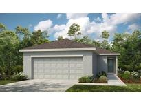Charming one-story home with a two-car garage, well-manicured lawn, and landscaped garden at 13287 Tropical Breeze Way, Hudson, FL 34669