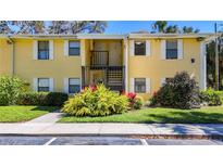 Inviting condo exterior with well-maintained landscaping, sidewalk, and charming architectural details at 3001 58Th S Ave # 912, St Petersburg, FL 33712