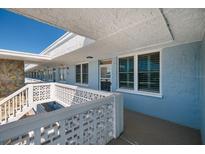 Inviting exterior condo hallway with patterned railing and a glimpse of the blue sky above at 4715 Bay Ne St # 323, St Petersburg, FL 33703