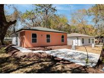 Charming brick home with a well-manicured lawn and inviting curb appeal on a sunny day at 10113 Huntley St, New Port Richey, FL 34654