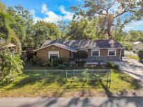 Charming fenced single-Gathering home featuring a well-maintained lawn and mature trees in a quiet neighborhood at 2412 Giddens Ave, Seffner, FL 33584