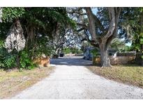 Long driveway leads to a cozy home with mature landscaping and a fenced yard at 3515 18Th E St, Bradenton, FL 34208