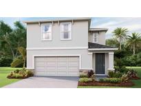 Two-story home featuring a front-entry garage, a neutral color palette, and complementary landscaping at 10605 Dusty Boot Rd, Land O Lakes, FL 34638