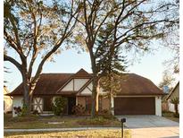 Charming two-story home with a well-maintained front yard and mature trees at 15013 Redcliff Dr, Tampa, FL 33625