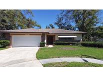 Charming single-story home featuring a well-maintained lawn and attached two-car garage at 2457 Orangepointe Ave, Palm Harbor, FL 34683