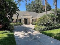 Charming single-story home with manicured landscaping and an inviting front entrance at 3336 Cobbs Ct, Palm Harbor, FL 34684