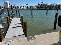 View of the private dock with weathered wood and calm, inviting waters at 337 Rex Pl # B, Madeira Beach, FL 33708