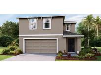 Charming two-story home with a modern design, landscaped yard, and a two-car garage at 5230 Salt Marsh Rd, Wimauma, FL 33598