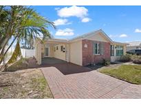 Charming single story home with brick facade, carport and a lush palm tree in the yard at 6140 Midnight Pass Rd, Sarasota, FL 34242
