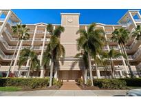 Beautiful condominium exterior with balconies and lush tropical landscaping at 7069 Key Haven Rd # 205, Seminole, FL 33777