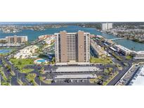 Spectacular aerial view of beachfront high-rise with tennis courts, pool and parking at 7300 Sun Island S Dr # 802, South Pasadena, FL 33707