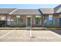 Charming townhome with brick facade, colorful shutters, and well-maintained landscaping at 8624 Carroll Oaks Dr, Tampa, FL 33614