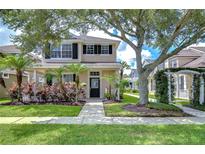 Charming two-story home with a landscaped front yard, mature trees, and inviting curb appeal in a desirable community at 8907 Ashford Gables, Tampa, FL 33626