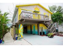 Colorful two-story home featuring a sun deck and bright, beachy accents at 2504 Avenue B # A, Bradenton Beach, FL 34217