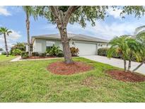 Charming single-story home featuring a well-manicured lawn and mature trees in a peaceful neighborhood setting at 29312 Marker Loop, San Antonio, FL 33576