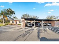 Charming home featuring a convenient carport with multiple parking spaces and mature landscaping at 3829 Trophy Blvd, New Port Richey, FL 34655