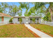 Charming single-story home featuring a manicured lawn, walkway and classic white picket fence at 5007 2Nd S Ave, St Petersburg, FL 33707