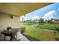 Outdoor patio offers relaxing space overlooking the lush landscaping with a calming water view and golf course at 5900 Bahia Del Mar Cir # 137, St Petersburg, FL 33715